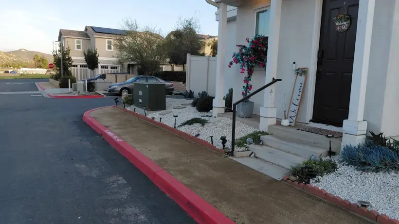 After: The same front entry after cleanup and the bed refresh.